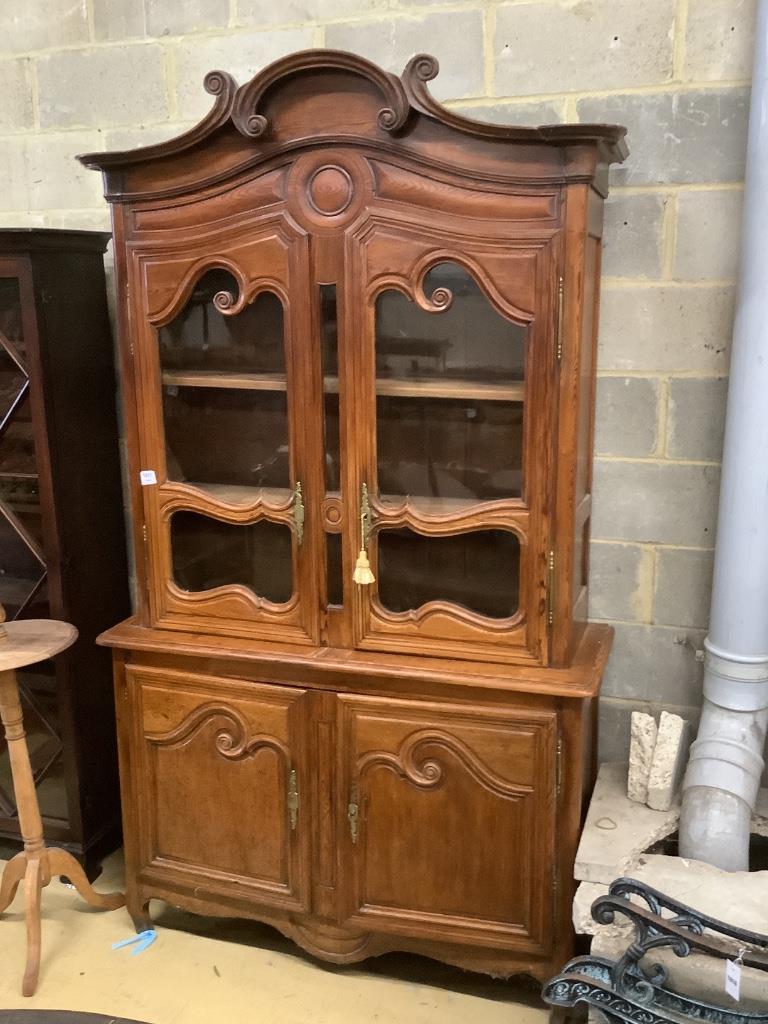 A 19th century French stained pine vitrine, with two glazed doors over panelled doors, width 133cm